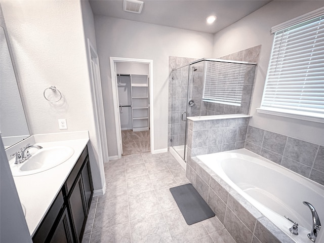 bathroom featuring tile patterned floors, vanity, and independent shower and bath