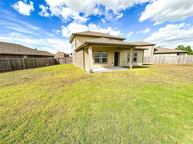 back of property featuring a patio area and a yard