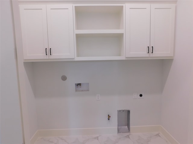 laundry room featuring cabinets, electric dryer hookup, gas dryer hookup, and washer hookup