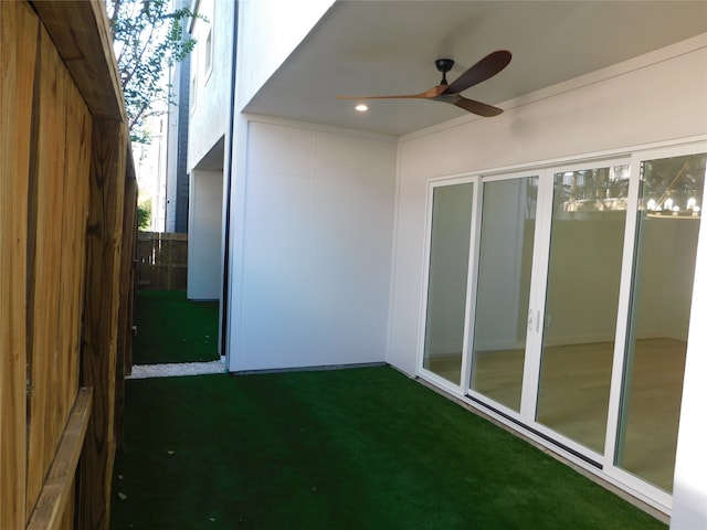 unfurnished sunroom featuring ceiling fan