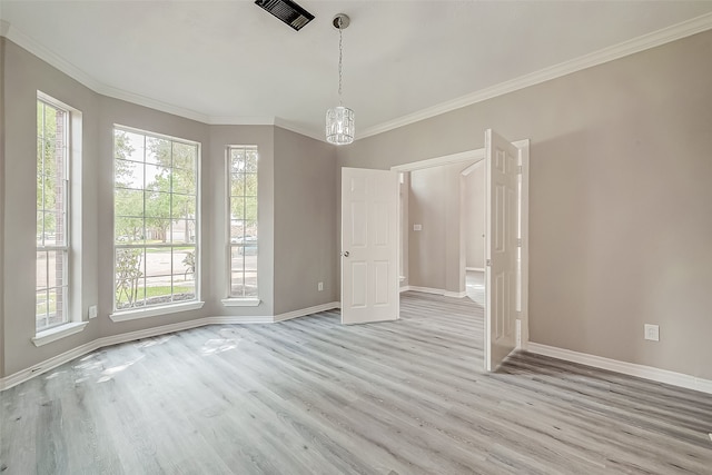 unfurnished dining area with light hardwood / wood-style flooring and ornamental molding