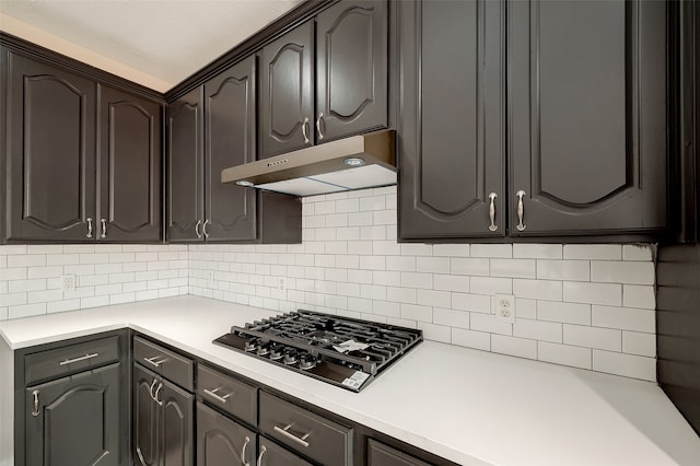 kitchen featuring tasteful backsplash, dark brown cabinetry, and gas cooktop