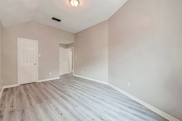 unfurnished bedroom featuring light hardwood / wood-style flooring and vaulted ceiling