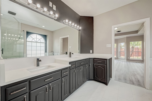 bathroom with hardwood / wood-style floors, vanity, and a shower with door