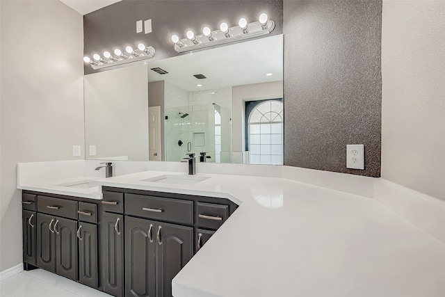 bathroom featuring vanity, tile patterned floors, and walk in shower