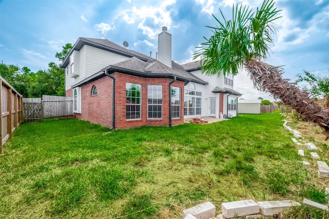 rear view of house featuring a lawn