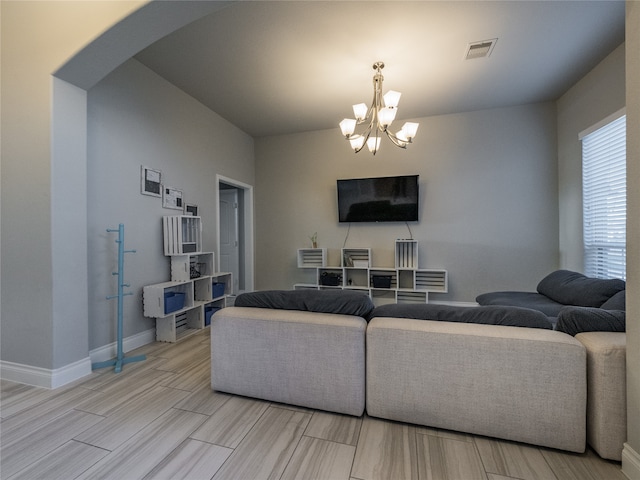 living room featuring light hardwood / wood-style flooring and a chandelier