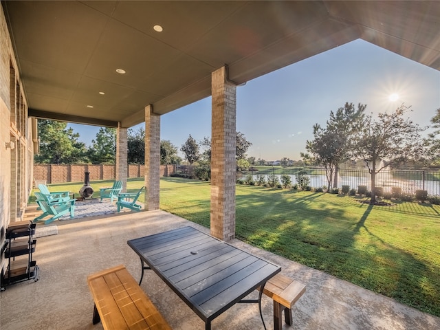 view of patio featuring a fire pit and a water view