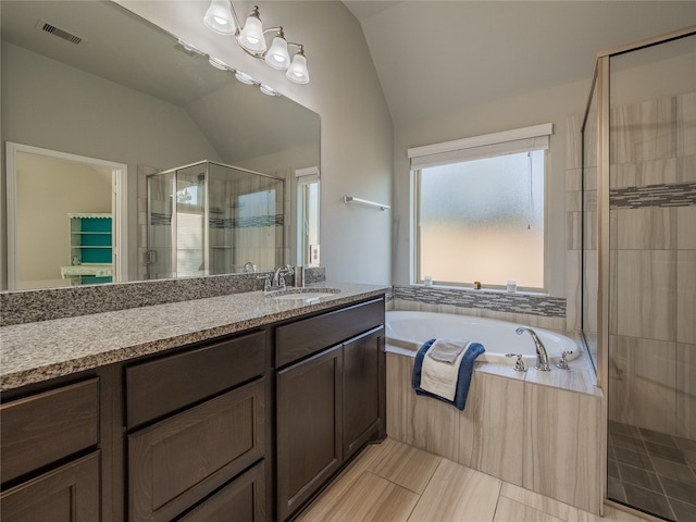 bathroom with separate shower and tub, tile patterned floors, vanity, and lofted ceiling