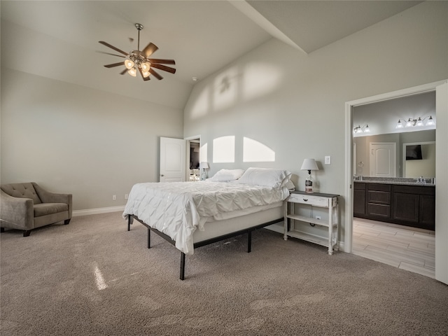 bedroom with ensuite bath, ceiling fan, high vaulted ceiling, and light colored carpet