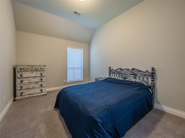 bedroom with carpet floors and vaulted ceiling