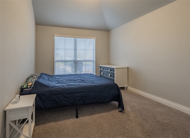 carpeted bedroom featuring lofted ceiling