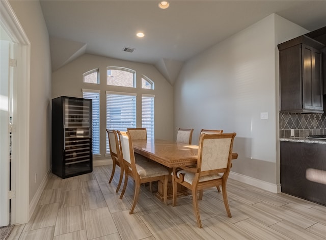 dining space featuring vaulted ceiling