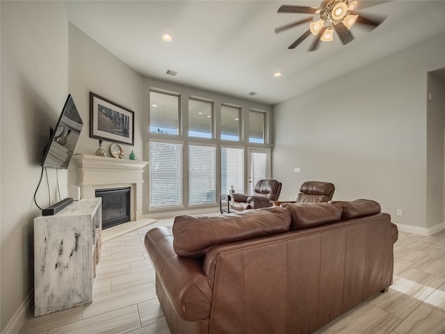 living room with ceiling fan and light hardwood / wood-style flooring