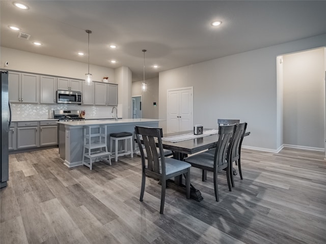 dining area featuring light hardwood / wood-style floors and sink