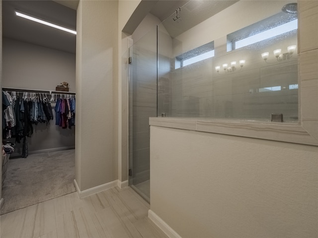 bathroom with a shower with shower door