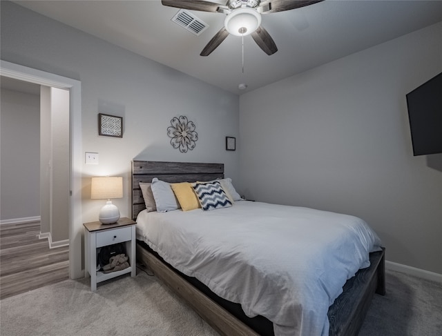 bedroom with hardwood / wood-style flooring and ceiling fan