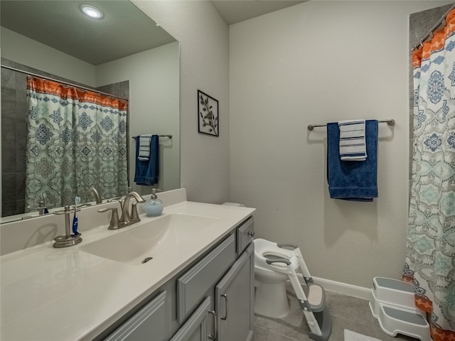 bathroom featuring tile patterned floors, vanity, and toilet