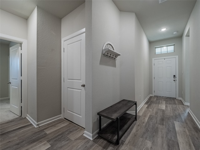 corridor with hardwood / wood-style floors