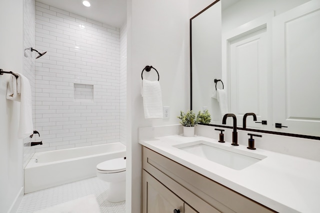 full bathroom featuring vanity, tiled shower / bath combo, tile patterned floors, and toilet