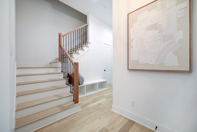 stairs featuring wood-type flooring