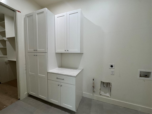 laundry area with gas dryer hookup, cabinets, hookup for a washing machine, electric dryer hookup, and tile patterned flooring