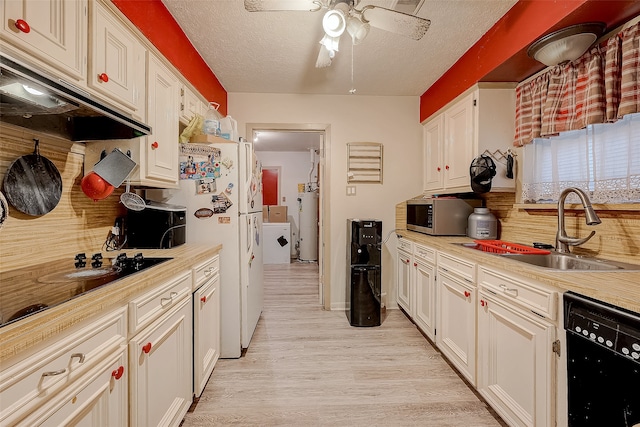 kitchen featuring sink, light wood-type flooring, a textured ceiling, black dishwasher, and white cabinetry