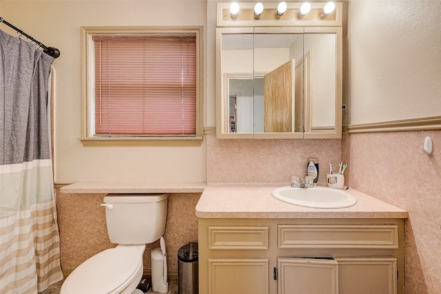 bathroom featuring walk in shower, vanity, tile walls, and toilet