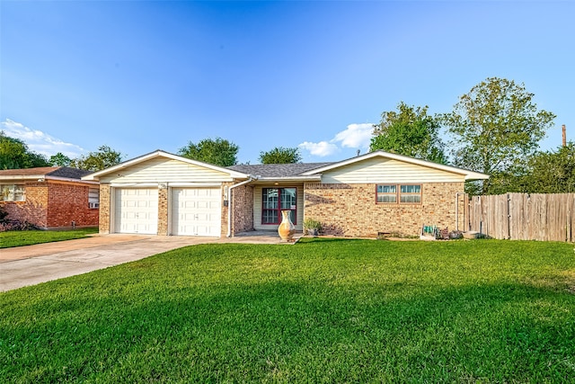 ranch-style home featuring a garage and a front lawn