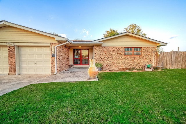 ranch-style home with a garage and a front yard