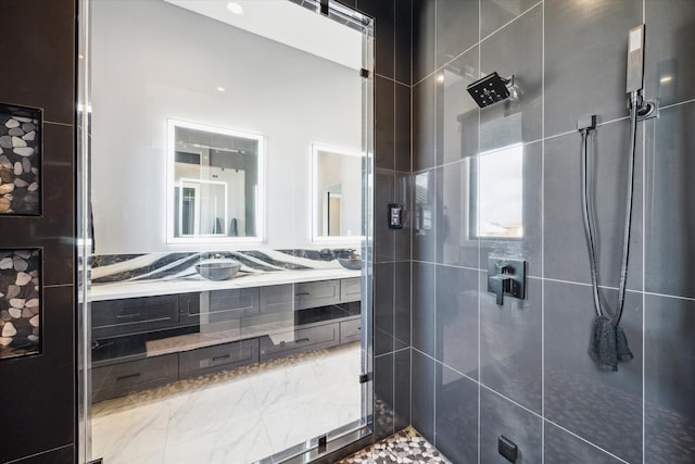 bathroom featuring vanity and tiled shower