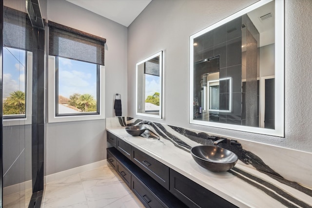 bathroom featuring vanity and tiled shower