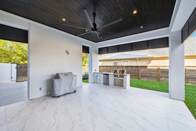 view of patio / terrace with a grill, ceiling fan, and an outdoor kitchen