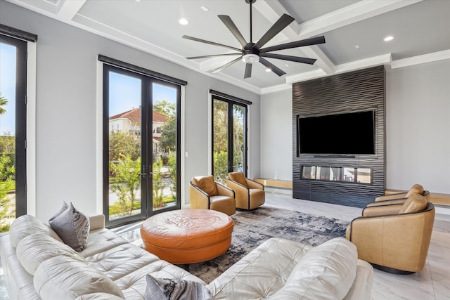 living room with french doors, ornamental molding, a large fireplace, ceiling fan, and beamed ceiling