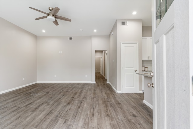 spare room featuring light hardwood / wood-style floors and ceiling fan