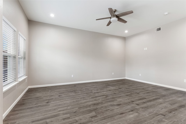 empty room featuring dark hardwood / wood-style flooring and ceiling fan