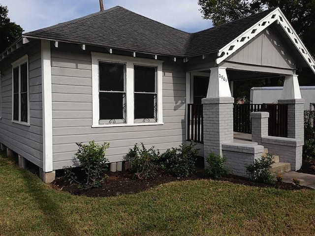 view of side of home with a lawn