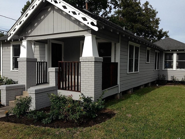 view of home's exterior with a yard and covered porch