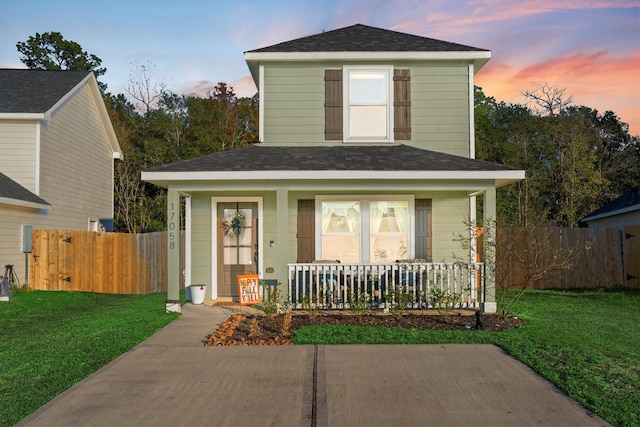 front of property featuring a lawn and a porch