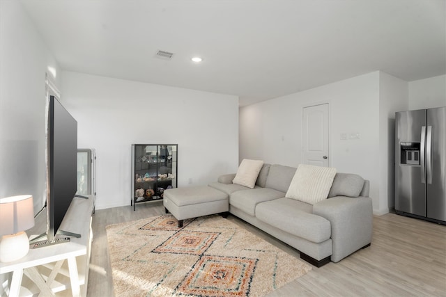 living room with light hardwood / wood-style flooring