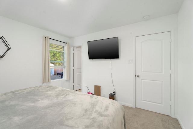 bedroom featuring light colored carpet