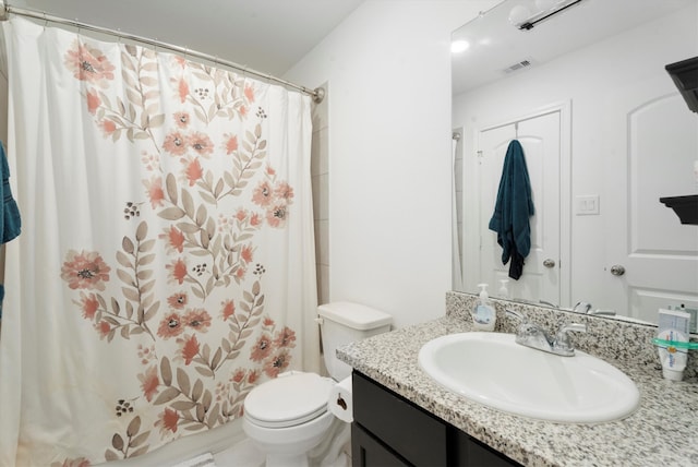 bathroom with vanity, toilet, and walk in shower