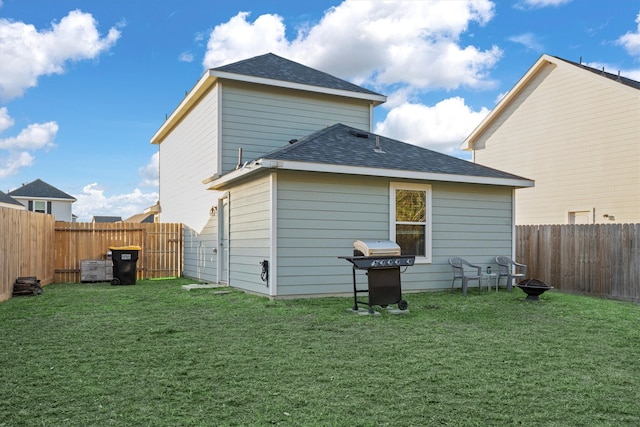 back of house with a lawn