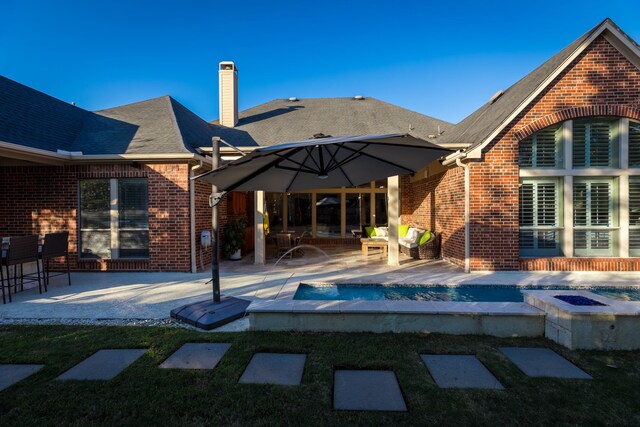 rear view of property featuring a patio area