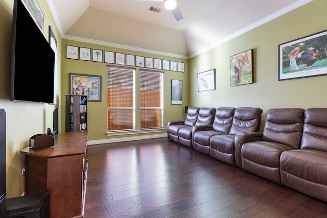 home theater featuring ceiling fan, dark wood-type flooring, vaulted ceiling, and ornamental molding