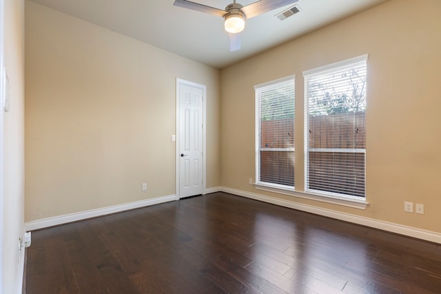 spare room featuring dark hardwood / wood-style floors and ceiling fan