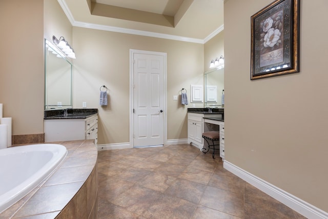 bathroom with vanity, crown molding, and tiled tub