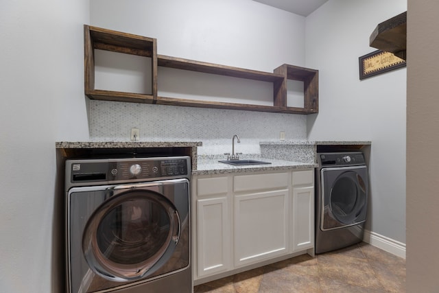 washroom featuring cabinets, washer / dryer, light tile patterned floors, and sink