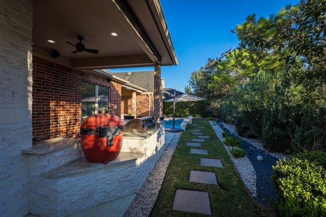 view of patio with ceiling fan and exterior kitchen