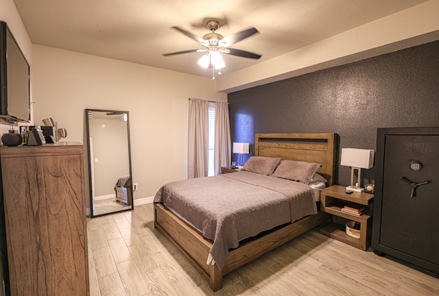 bedroom featuring ceiling fan and light hardwood / wood-style floors